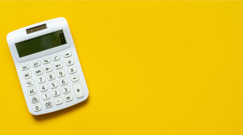 close-up-top-view-white-calculator-on-yellow-background-with-for-picture-id1159599930  - Professional Beauty